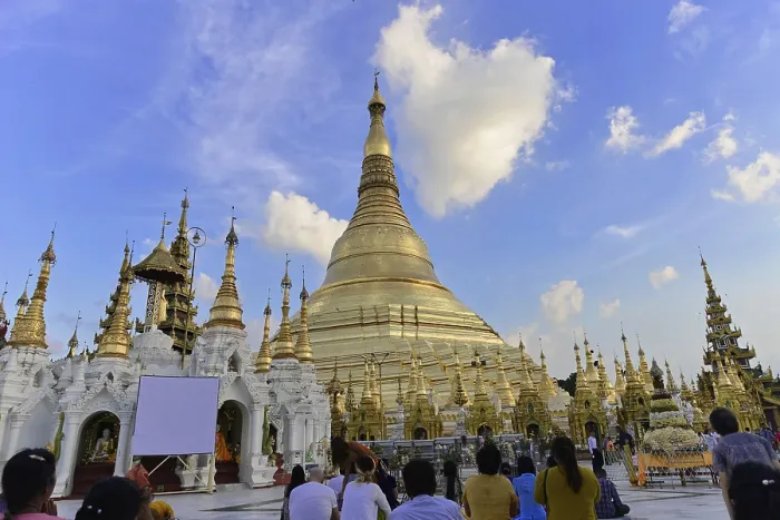 Framed Print : People gather to pray at a famous pagoda under a blue sky