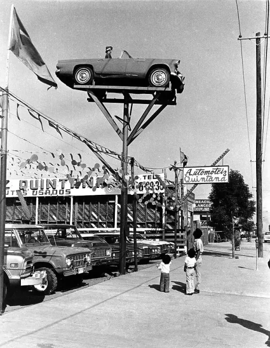 Framed Print : People gazing at car in the air Framed Print : People gazing at car in the air
