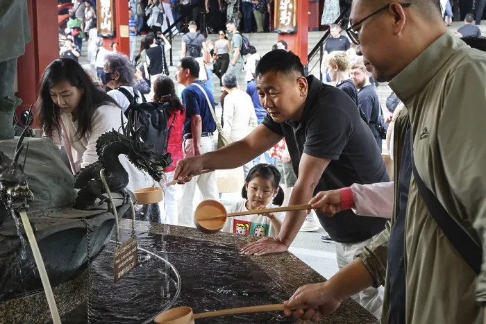 Framed Print : People purify themselves at a purification well in Senso-ji Temple Framed Print : People purify themselves at a purification well in Senso-ji Temple