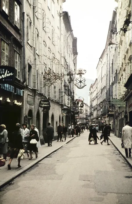 Framed Print : People shopping city centre alleyway of Getreidegasse, prominent guild sign for Wirtshausschild Sternbraeu, Salzburg, Austria, Europe 1960, Europe