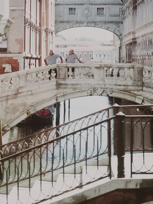 Framed Print : Two people standing on a historic Sighs bridge over a canal on a sunny day