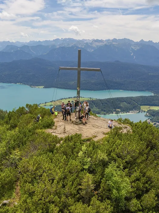 Framed Print : People standing around a summit cross with a view of the surrounding landscape
