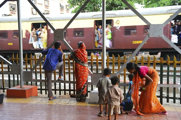 Framed Print : People at station watching train passing