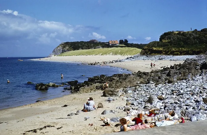 Framed Print : People sunbathing on the beach at Priory Bay, Caldey Island, Pembrokeshire Wales, United Kingdom in the late 1950s