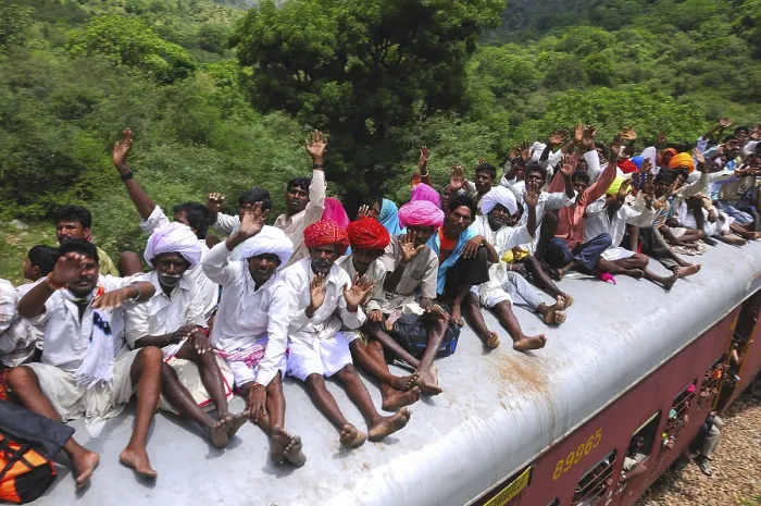 Framed Print : People taking risk while travelling on roof of train