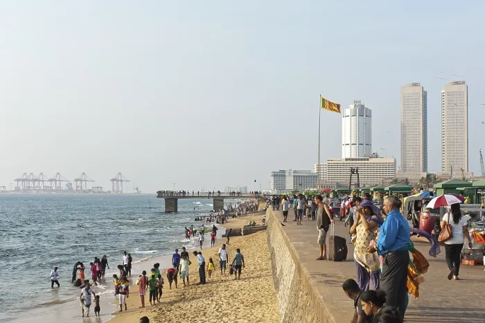 Framed Print : People walk along the beach promenade Framed Print : People walk along the beach promenade