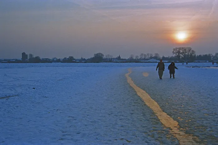 Framed Print : People walk across ice rink, sunset Framed Print : People walk across ice rink, sunset