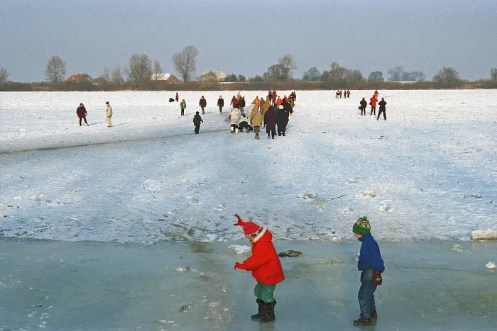 Framed Print : People walking across ice rink