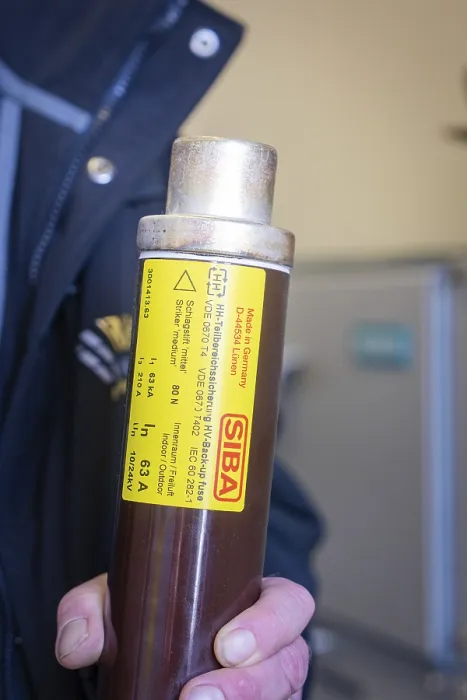 Framed Print : Person holding fuse with SIBA label