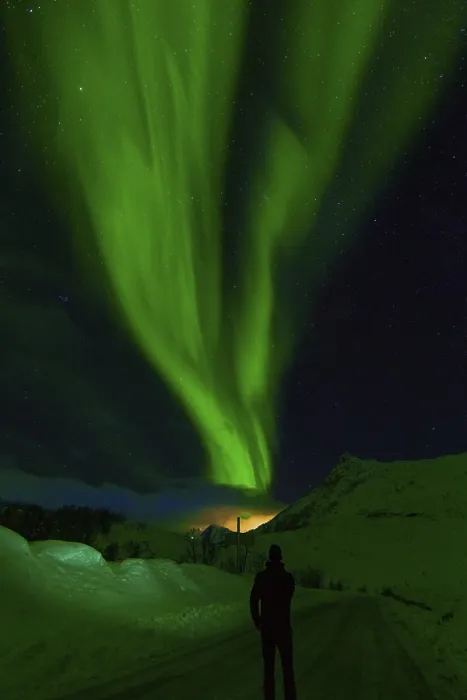 Framed Print : Person observes striking green aurora borealis against a clear starry night