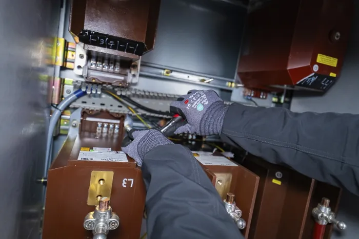 Framed Print : Person wearing gloves working on an electrical switch box Framed Print : Person wearing gloves working on an electrical switch box
