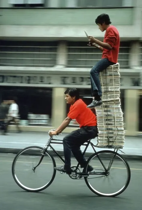 Framed Print : Two Persons and Newspapers on Bike Framed Print : Two Persons and Newspapers on Bike