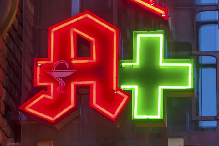 Framed Print : Pharmacy sign, pharmacy logo, red A with Aesculapian snake at dusk