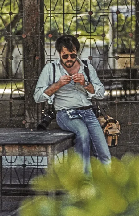 Framed Print : Photographer rolling a cigarette