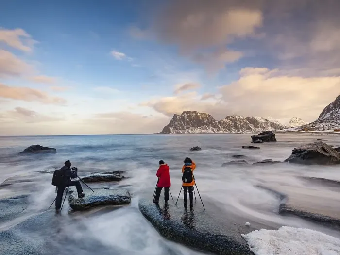 Framed Print : Photographers with tripod on smooth rocks on Utakleiv beach in a dramatic cloudy atmosphere