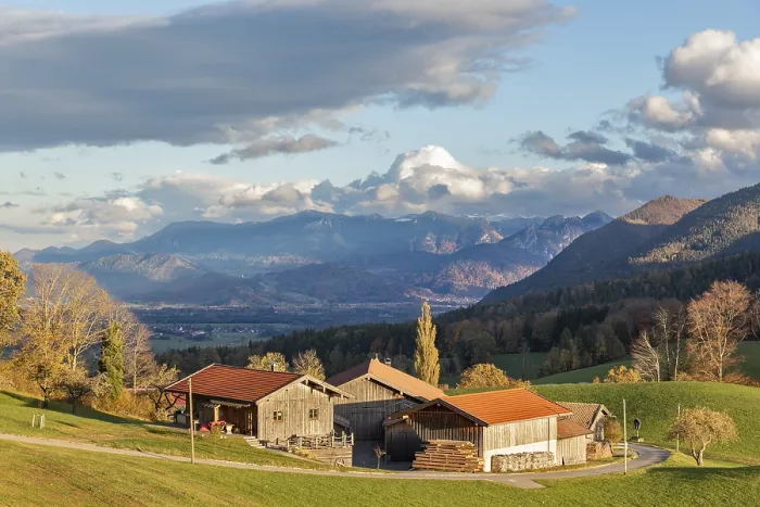 Framed Print : A picturesque farm in front of a mountain backdrop in autumn light