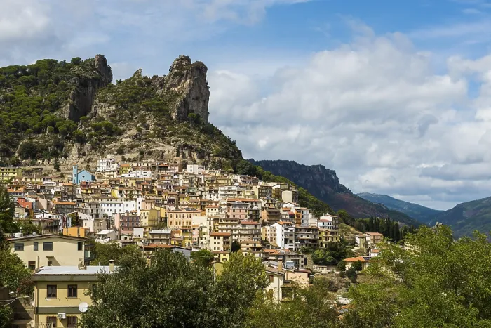 Framed Print : Picturesque village and steep mountains