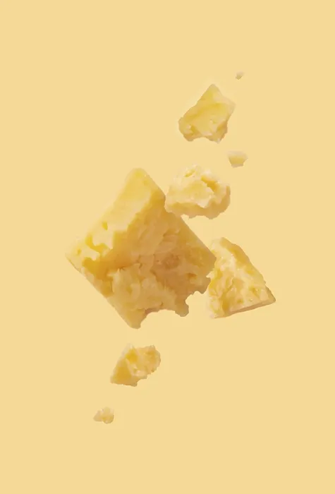 Framed Print : Pieces of cheese on a yellow background Framed Print : Pieces of cheese on a yellow background
