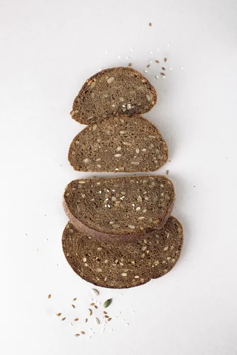 Framed Print : Pieces of rye bread with seeds, flat lay