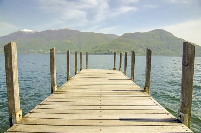 Framed Print : Pier over Alpine Lake Maggiore and Mountain with Blue Sky and Clouds in Ticino