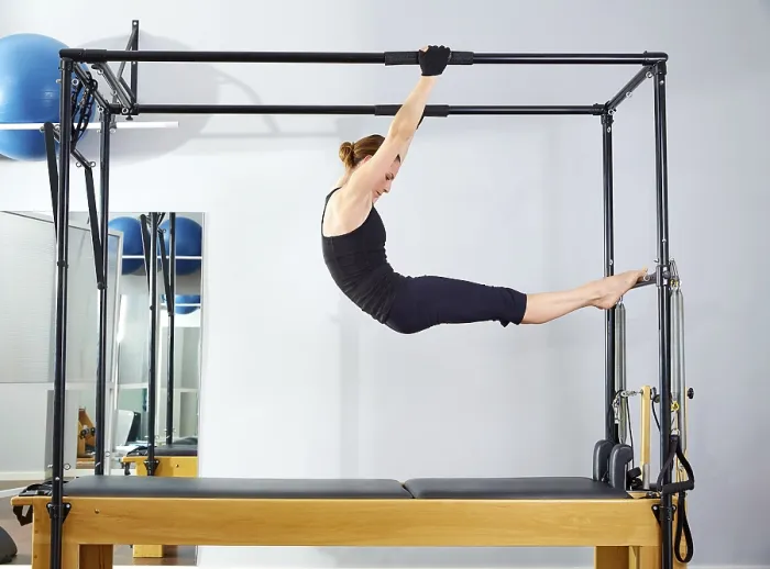Framed Print : Pilates woman in cadillac acrobatic reformer exercise at gym Framed Print : Pilates woman in cadillac acrobatic reformer exercise at gym