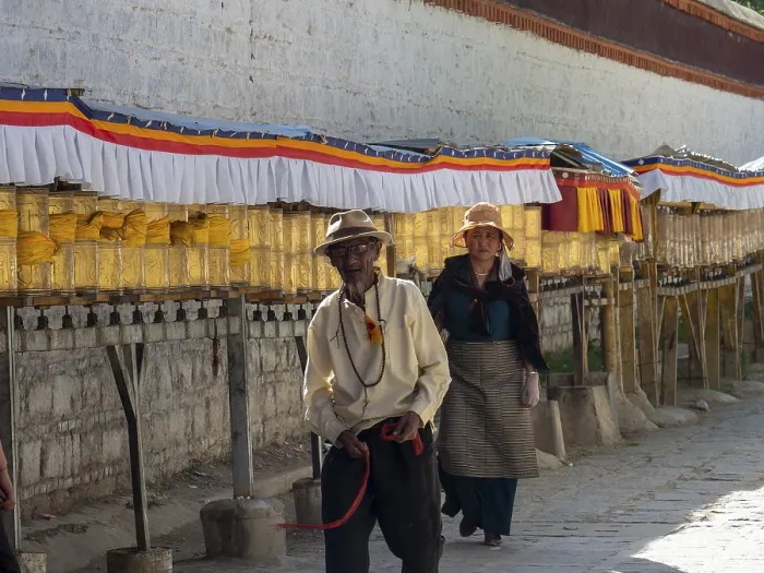 Framed Print : Pilgrims at golden prayer wheels