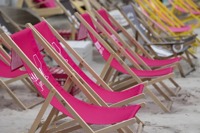 Framed Print : Pink deckchairs are set up on the beach and convey a summery feeling Framed Print : Pink deckchairs are set up on the beach and convey a summery feeling