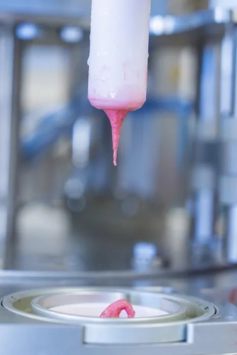 Framed Print : Pink liquid ice cream drips from a machine into a container Framed Print : Pink liquid ice cream drips from a machine into a container