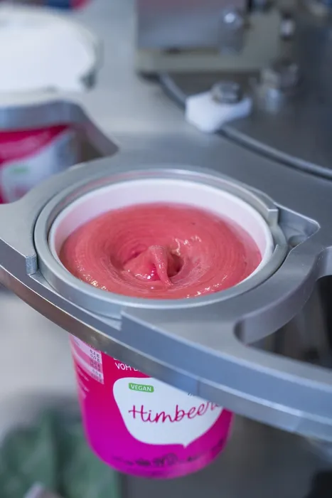 Framed Print : Pink raspberry ice cream is filled into a vegan sundae