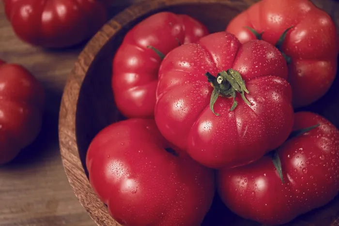 Framed Print : Pink tomatoes, in a rustic wooden bowl Framed Print : Pink tomatoes, in a rustic wooden bowl