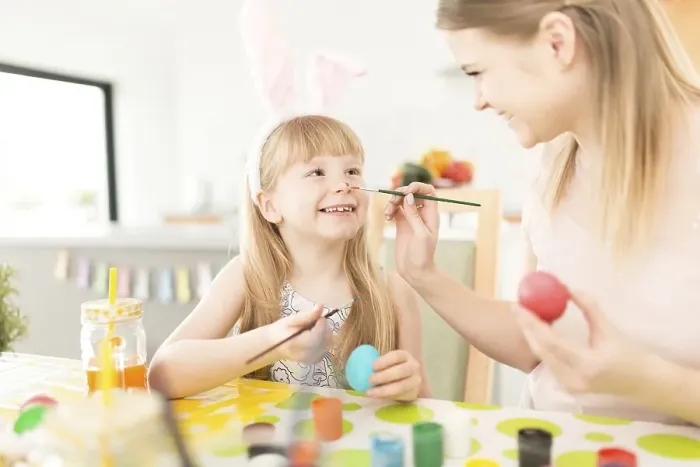 Framed Print : Playful woman with daughter preparing easter