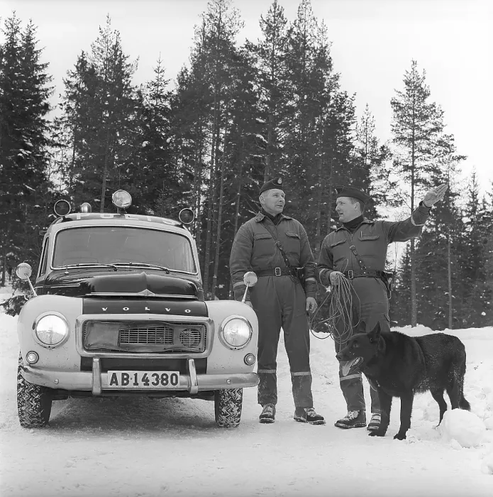 Framed Print : Policemen with search dog 1969. Two policemen with a dog used to search and find missing people at their policecar a Volvo duett. The model was produced between 1953-1969. Svahn