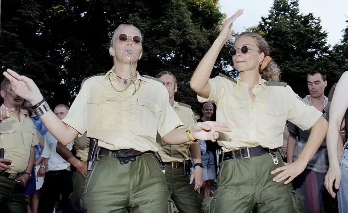 Framed Print : Policewomen of the Berlin police celebrate with techno fans during the Love Parade