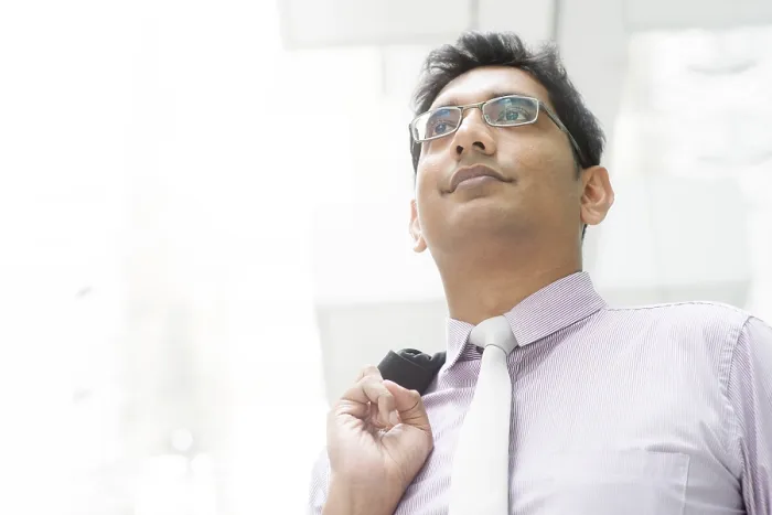 Framed Print : Portrait of 30s Asian Indian businessman looking away outside office Framed Print : Portrait of 30s Asian Indian businessman looking away outside office