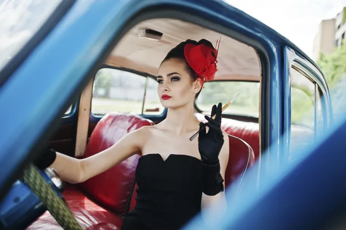 Framed Print : Portrait of beautiful sexy fashion girl model with bright makeup in retro style sitting in vintage car with a cigarette