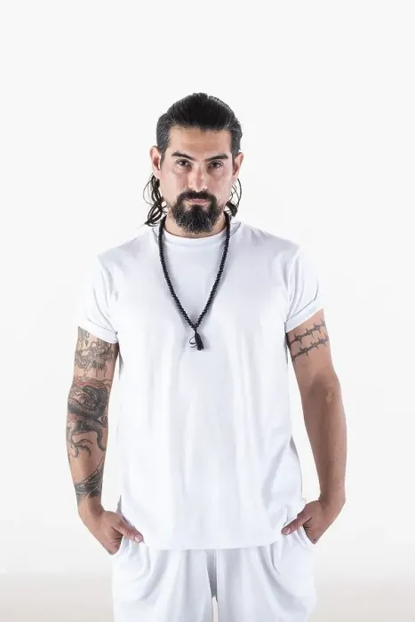 Framed Print : Portrait of a man dressed in white yoga clothes over white background while looking at camera
