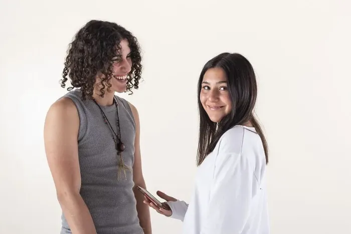 Framed Print : Portrait of a young couple dressed in yoga clothes laughing over white background