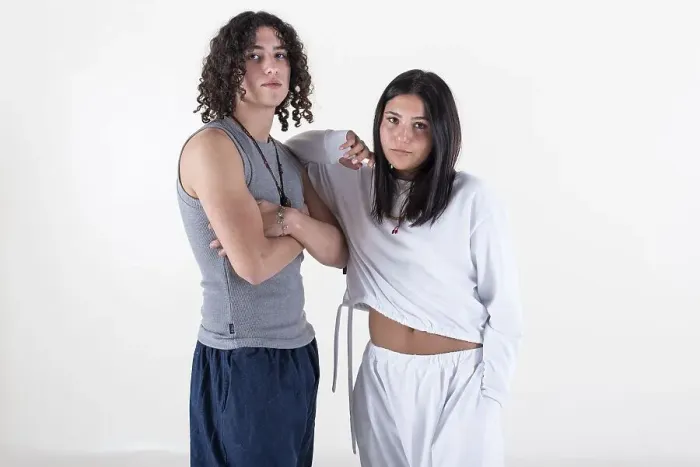 Framed Print : Portrait of a young couple dressed in yoga clothes looking ti the camera white background Framed Print : Portrait of a young couple dressed in yoga clothes looking ti the camera white background