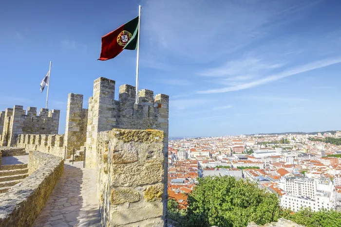 Framed Print : Portugal flag waving on ancient fortress wall of Sao Jorge Castle