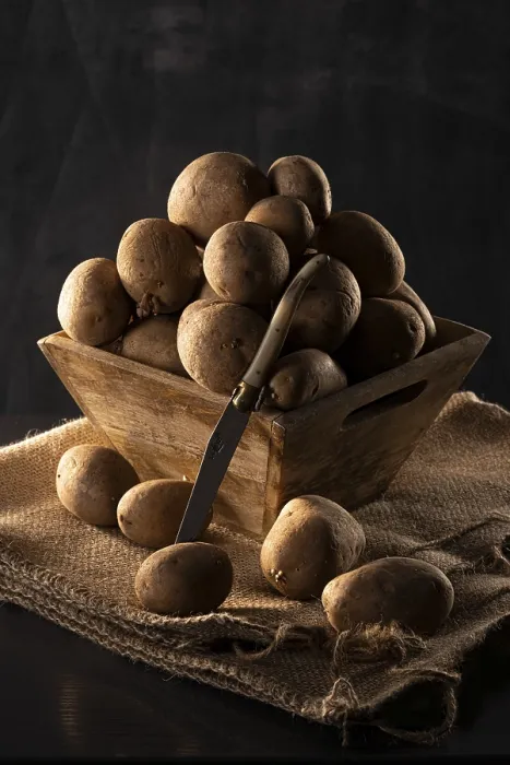 Framed Print : Potatoes in a wooden bowl, still life