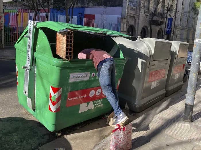 Framed Print : Poverty in Buenos Aires, a homeless man searches for something usable in a rubbish container Framed Print : Poverty in Buenos Aires, a homeless man searches for something usable in a rubbish container