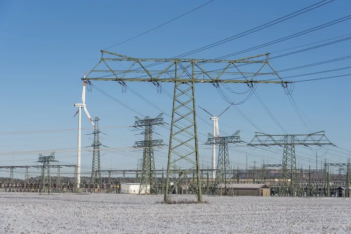 Framed Print : Power pylons, wind turbines, icy field Framed Print : Power pylons, wind turbines, icy field