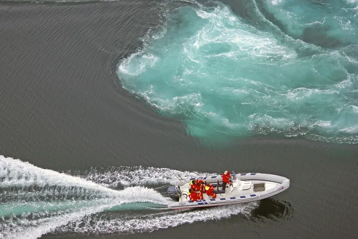 Framed Print : Powerboat with passengers between tidal eddies in the sea Framed Print : Powerboat with passengers between tidal eddies in the sea