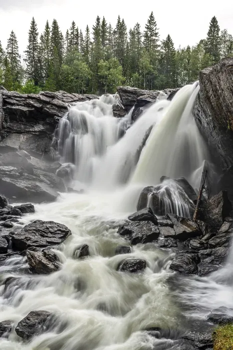 Framed Print : Powerful, foaming waterfall surrounded by trees through rough rocks Framed Print : Powerful, foaming waterfall surrounded by trees through rough rocks