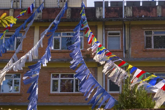 Framed Print : Prayer flags in front of a facade