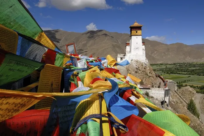 Framed Print : Prayer flags are flying on Yumbulagang Palace above the Yarlung Valley