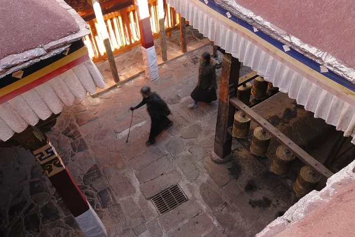 Framed Print : Prayer wheels and Tibetan pilgrims near the Kora
