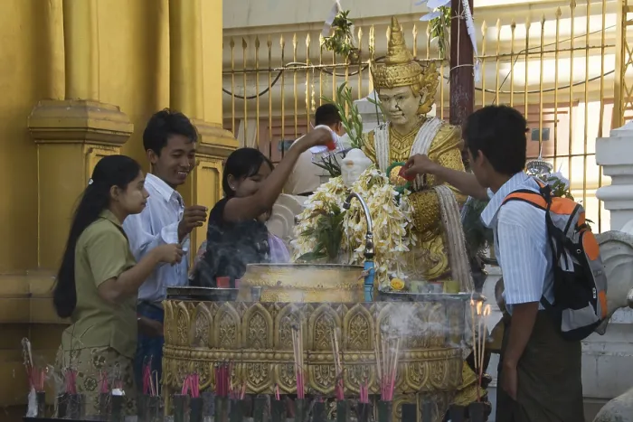 Framed Print : Praying worshippers make offerings to Buddha