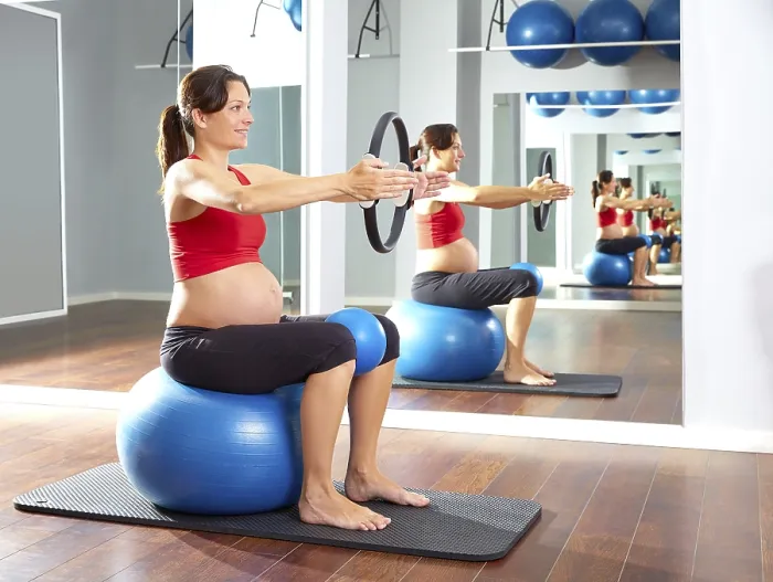 Framed Print : Pregnant woman pilates exercise magic ring with fitball