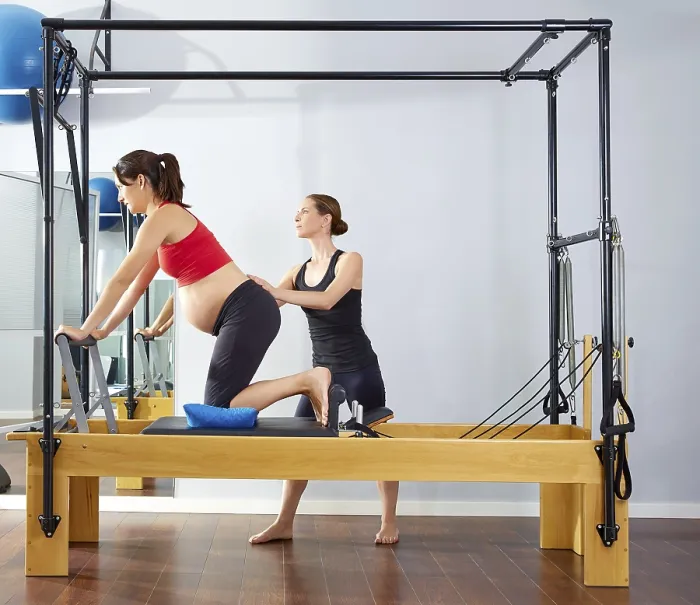 Framed Print : Pregnant woman pilates reformer cadillac exercise workout with personal trainer Framed Print : Pregnant woman pilates reformer cadillac exercise workout with personal trainer